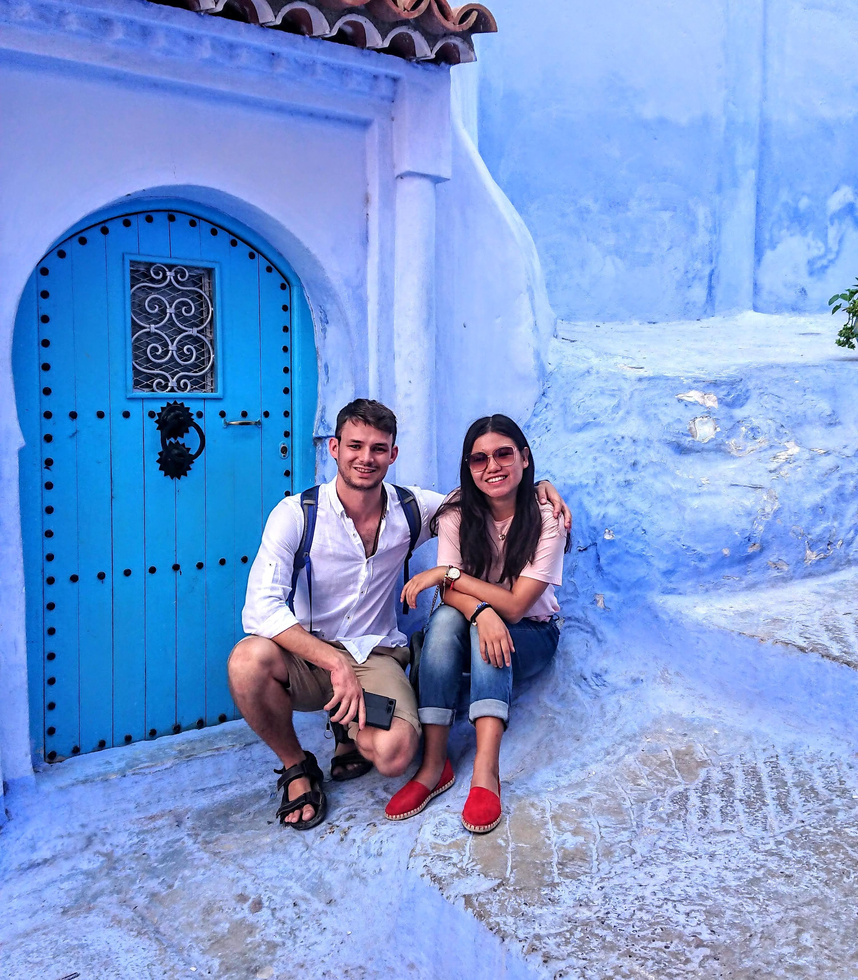 Martin and Jing with a beautiful blue building behind them with a blue door